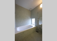 こだわりの浴室。壁と床は十和田石を使用。
光を反射せず優しい表情になる。